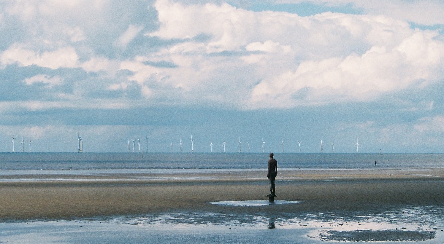 Offshore wind turbines of Burbo Bank seen across the water from Crosby; no inspection vehicle appears in the photo.