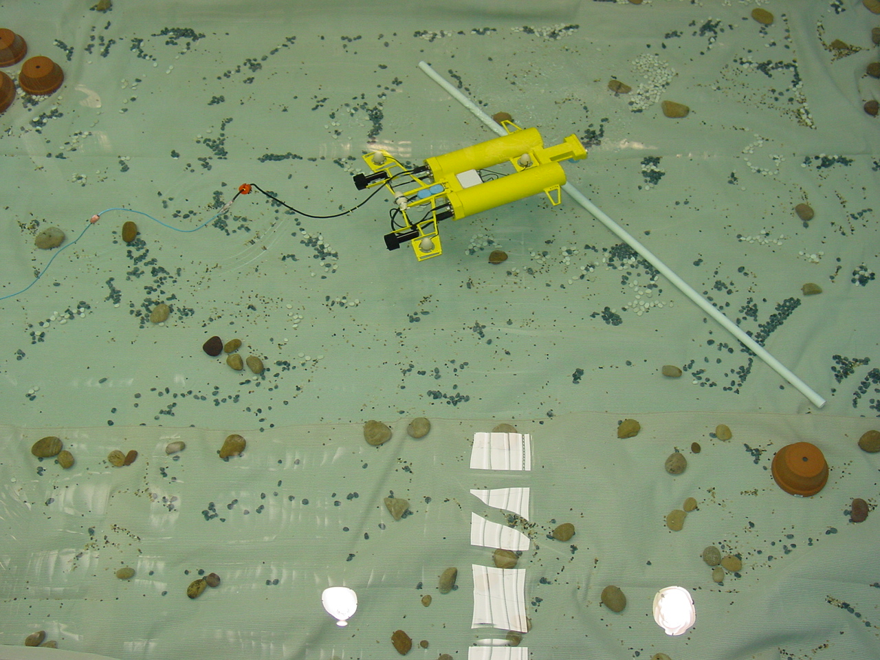 Remotely operated vehicle undergoing tests in a clear swimming pool
