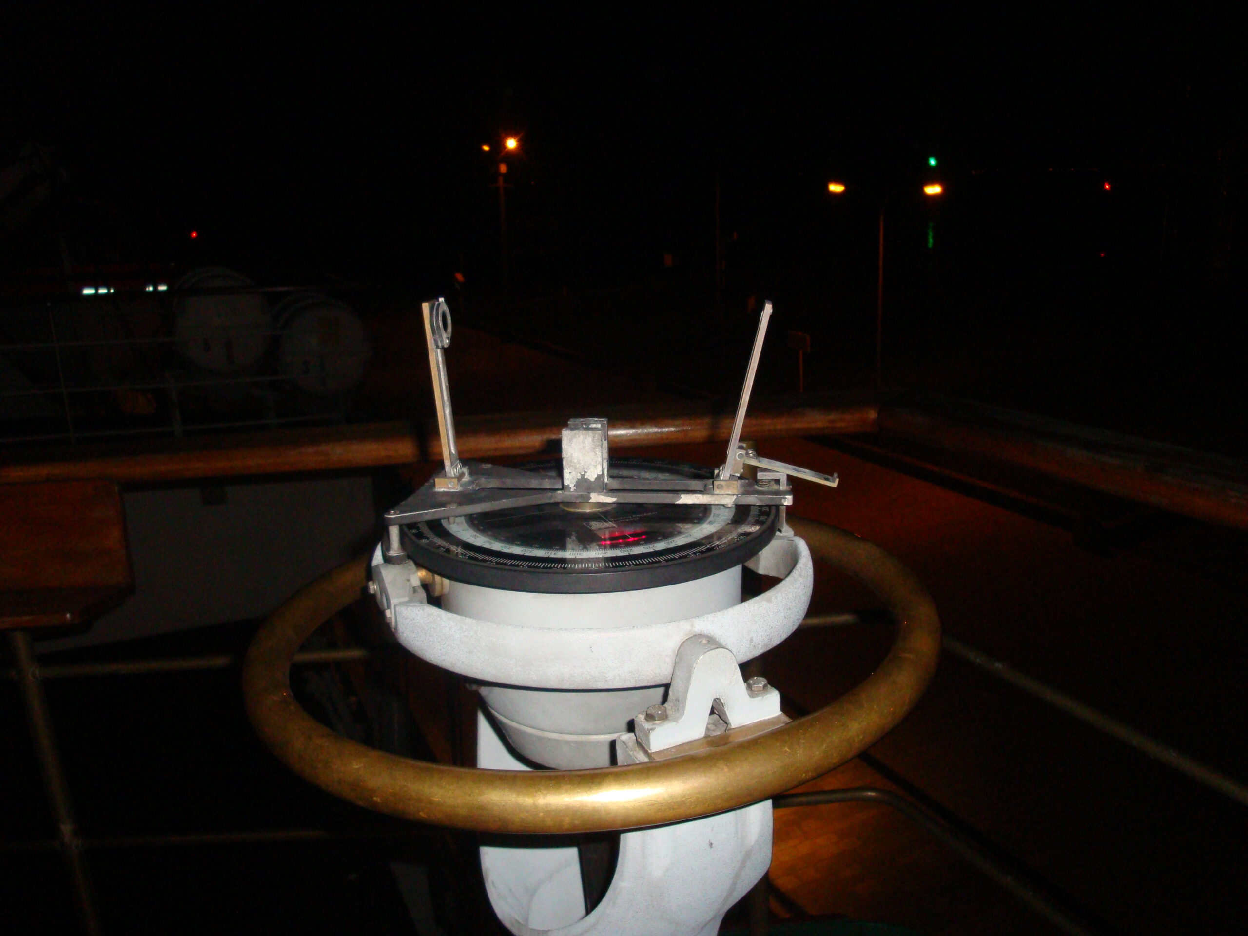 Navigational heading instrument on a ship bridge wing at the helm area