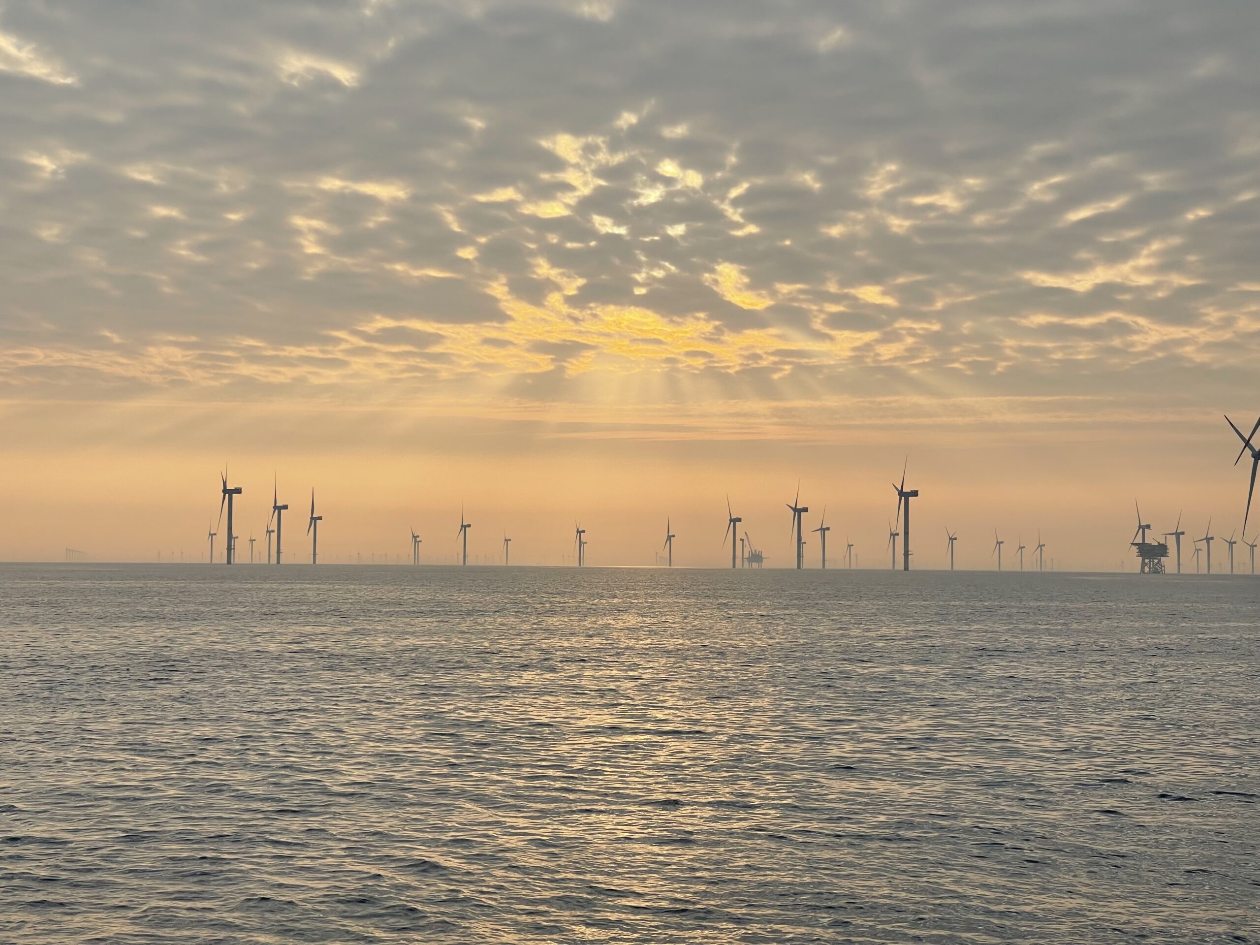 Offshore wind turbines standing in open water at the Nordsee One wind farm; no ROV is visible in the frame.