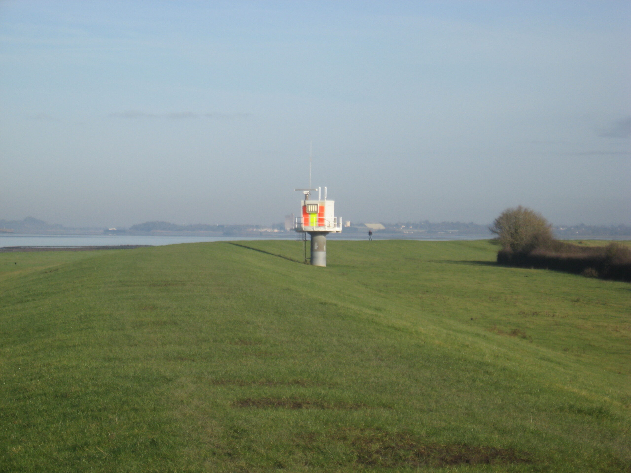 Marine radar scanner and navigational beacon mounted on shore beside the Severn