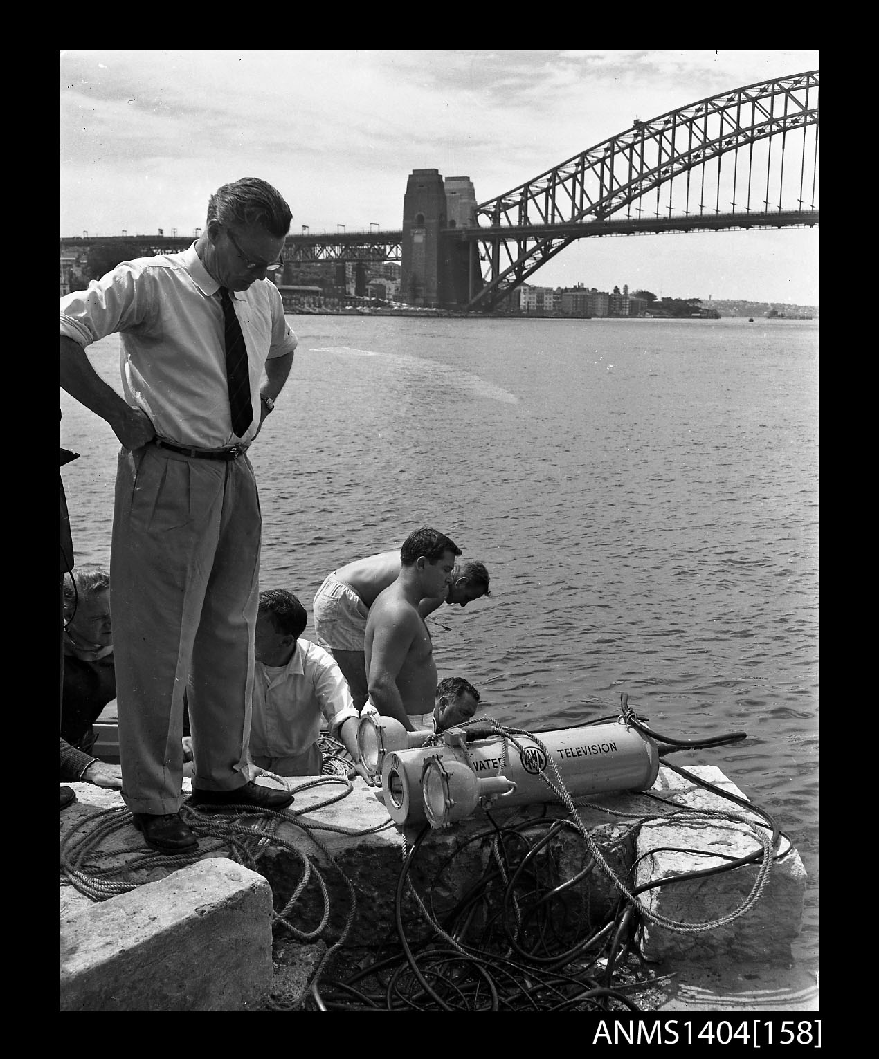 Vintage underwater television camera on a stand near the water